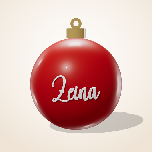 Red Christmas ball ornament with the name Zeina in white letters
