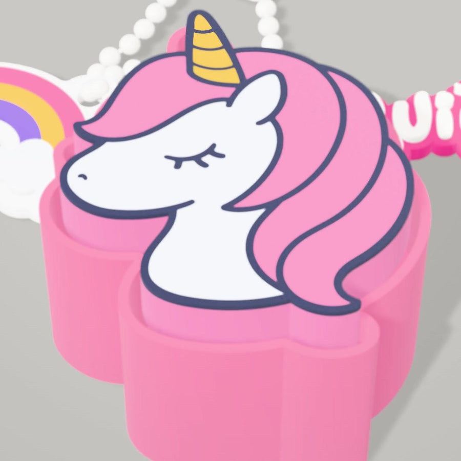 Close-up of a pink unicorn clicker on a ball chain